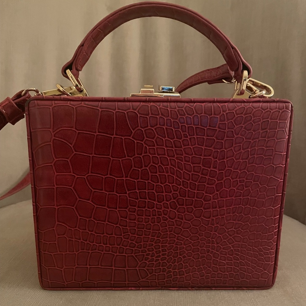 Free People cross body red leather rectangular bag with latch.